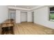 Finished basement with light wood floors, white walls, and built-in dog kennels at 7407 Forney Hill Rd, Denver, NC 28037