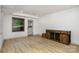 Finished basement featuring light wood flooring, bright walls, and a window for natural light at 7407 Forney Hill Rd, Denver, NC 28037