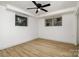 Bright basement space featuring vinyl floors, white walls, and natural lighting from two windows at 7407 Forney Hill Rd, Denver, NC 28037