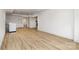 Large basement area with light wood flooring, white walls, modern washer, and access to various rooms at 7407 Forney Hill Rd, Denver, NC 28037