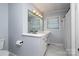 Bathroom featuring a sleek white vanity with drawers and a large mirror with Hollywood-style lighting at 7407 Forney Hill Rd, Denver, NC 28037