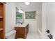 Bathroom with a wooden vanity, white marble floors, and a bathtub with a tiled wall at 7407 Forney Hill Rd, Denver, NC 28037
