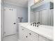 Bathroom with white cabinets, double sinks, a big mirror and marble floor tiles at 7407 Forney Hill Rd, Denver, NC 28037