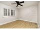 A room featuring vinyl floors, a geometric accent wall, and plantation shutters at 7407 Forney Hill Rd, Denver, NC 28037