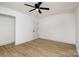 Bright, minimalist bedroom featuring light wood floors, white walls, and neutral decor at 7407 Forney Hill Rd, Denver, NC 28037