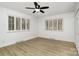 Bright bedroom with vinyl floors, plantation shutters, and a ceiling fan at 7407 Forney Hill Rd, Denver, NC 28037