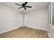 Bright bedroom featuring neutral decor, wood-look flooring, and a modern ceiling fan at 7407 Forney Hill Rd, Denver, NC 28037