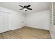 Bright bedroom with a ceiling fan, vinyl floors, white walls, and a closet at 7407 Forney Hill Rd, Denver, NC 28037