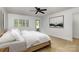 Bright bedroom with a minimalist design, light wood floors, and a door leading to the outside at 7407 Forney Hill Rd, Denver, NC 28037