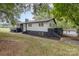 Two-story home featuring a white and gray exterior surrounded by lush greenery and grass at 7407 Forney Hill Rd, Denver, NC 28037