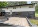 The rear exterior reveals a gray brick base and white siding, complemented by a tiled patio at 7407 Forney Hill Rd, Denver, NC 28037