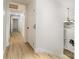 Bright hallway featuring wood-look floors, white walls, and an elegant chandelier near the main entrance at 7407 Forney Hill Rd, Denver, NC 28037