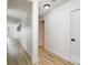 Neutral hallway with vinyl floors, white walls, and modern lighting, creating a clean aesthetic at 7407 Forney Hill Rd, Denver, NC 28037