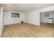 Bright laundry room with wood-look floors and an adjacent room with laundry machines at 7407 Forney Hill Rd, Denver, NC 28037