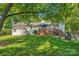 Beautiful backyard with green lawn, shed, and wooden deck, perfect for outdoor enjoyment at 7613 Whistlestop Rd, Charlotte, NC 28210
