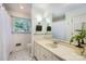 Bright bathroom featuring black and white tile floors, a large mirror, and natural light, along with storage and decor at 7613 Whistlestop Rd, Charlotte, NC 28210