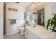 Clean bathroom featuring a classic white vanity, tiled floors, and a glass-enclosed shower, plus natural light at 7613 Whistlestop Rd, Charlotte, NC 28210