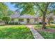 Charming white house with lush front yard, sidewalk leading to the front door at 7613 Whistlestop Rd, Charlotte, NC 28210