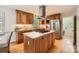 Kitchen featuring wooden cabinetry, stainless steel appliances, and a central island at 7613 Whistlestop Rd, Charlotte, NC 28210