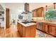Well-equipped kitchen with stainless steel appliances, wooden cabinets, and an island at 7613 Whistlestop Rd, Charlotte, NC 28210