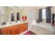 Bright bathroom with a double vanity, large mirror and soaking tub at 803 Coach House Ct, Rock Hill, SC 29730