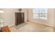 Neutral bedroom with a decorative dresser, lamp and large window at 803 Coach House Ct, Rock Hill, SC 29730