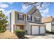Charming two-story home with brick accents, a two-car garage, and well-maintained lawn and siding at 803 Coach House Ct, Rock Hill, SC 29730