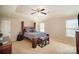 Spacious primary bedroom with a king-sized bed, ceiling fan, and natural light at 803 Coach House Ct, Rock Hill, SC 29730