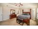 Primary bedroom showcasing a bed, ceiling fan, dresser, and a well-lit interior at 803 Coach House Ct, Rock Hill, SC 29730