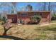 Brick home exterior with a grassy backyard, offering an inviting outdoor space at 8101 Kerrybrook Cir, Charlotte, NC 28214