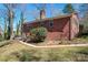Brick home exterior with a large grassy backyard at 8101 Kerrybrook Cir, Charlotte, NC 28214
