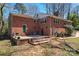 Brick home exterior with a concrete patio area, offering an inviting outdoor space at 8101 Kerrybrook Cir, Charlotte, NC 28214