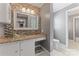 Stylish bathroom featuring a granite countertop vanity with a glass vessel sink and mosaic tile accent wall at 8101 Kerrybrook Cir, Charlotte, NC 28214