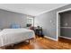 Bedroom features hardwood floors, gray walls, a bed, and a desk area at 8101 Kerrybrook Cir, Charlotte, NC 28214