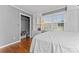 Cozy bedroom with hardwood floors, a window, built-in storage, and a closet at 8101 Kerrybrook Cir, Charlotte, NC 28214