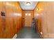 Inviting entryway with wood paneling, a front door with glass accents, and practical storage at 8101 Kerrybrook Cir, Charlotte, NC 28214