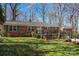 Attractive brick home with a green lawn, showcasing the front facade, porch, and landscaping at 8101 Kerrybrook Cir, Charlotte, NC 28214