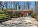 Charming single-story brick home with a lush front yard, a cozy porch, and driveway parking at 8101 Kerrybrook Cir, Charlotte, NC 28214