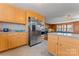 Kitchen featuring light wood cabinets, stainless steel appliances, and a large island at 8101 Kerrybrook Cir, Charlotte, NC 28214
