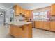 Well-lit kitchen with light wood cabinetry, stainless steel appliances, and a large sink at 8101 Kerrybrook Cir, Charlotte, NC 28214