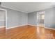 Open-concept living area with hardwood floors and neutral gray walls at 8101 Kerrybrook Cir, Charlotte, NC 28214