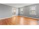 Spacious living room with hardwood floors and large windows offering plenty of natural light at 8101 Kerrybrook Cir, Charlotte, NC 28214