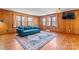 Spacious living room with hardwood floors, wood paneling, and large windows for natural light at 8101 Kerrybrook Cir, Charlotte, NC 28214