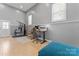 Bright, tiled room featuring an office area, gym equipment and natural light through the windows at 8101 Kerrybrook Cir, Charlotte, NC 28214