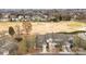 A lovely aerial view of townhomes overlooking a beautifully maintained golf course and surrounded by lush trees at 8412 Brookings Dr, Charlotte, NC 28269