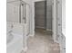 Bright bathroom featuring a soaking tub, a glass shower, and access to a spacious walk-in closet at 8412 Brookings Dr, Charlotte, NC 28269