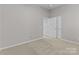Bedroom featuring a closet with sliding doors and neutral carpet at 8412 Brookings Dr, Charlotte, NC 28269