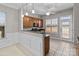 Bright dining area featuring wood cabinets, granite counters, and access to the backyard at 8412 Brookings Dr, Charlotte, NC 28269