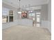 Open-concept dining area with large windows, pendant lighting, wainscoting, and a view of the kitchen with bar seating at 8412 Brookings Dr, Charlotte, NC 28269