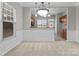 Open dining area with wainscoting and views into the kitchen at 8412 Brookings Dr, Charlotte, NC 28269